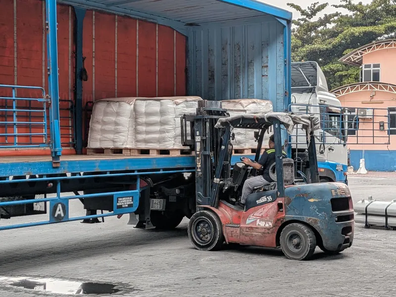 Forklift loading a pallet onto a truck
