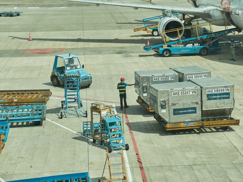 Air cargo containers being moved to an aircraft on the apron